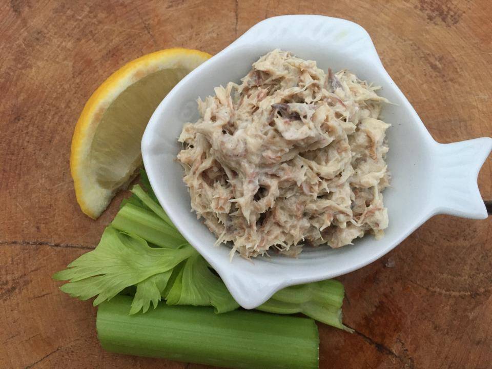 Quick and easy mackerel pate in white fish shaped dish with lemon and celery.