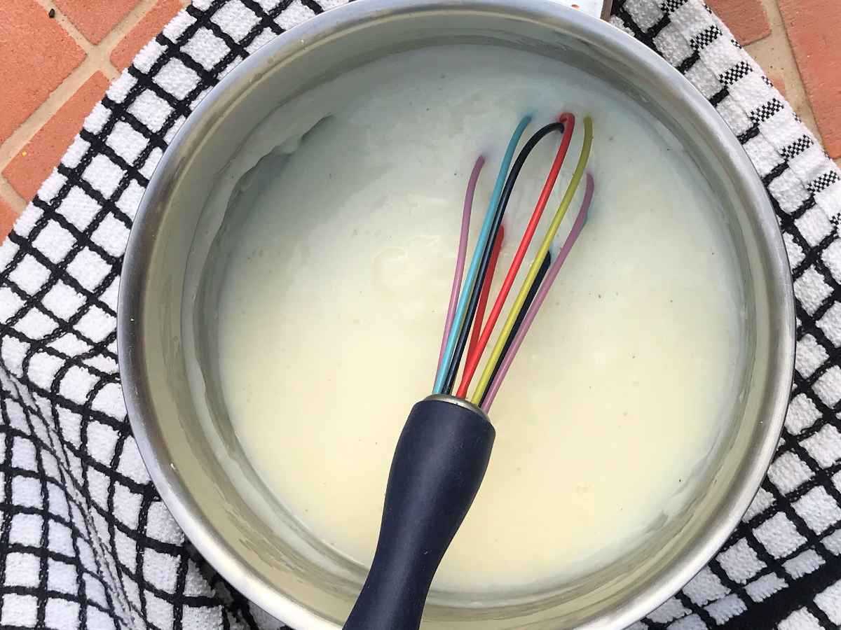 Making white sauce with cornflour in a pan