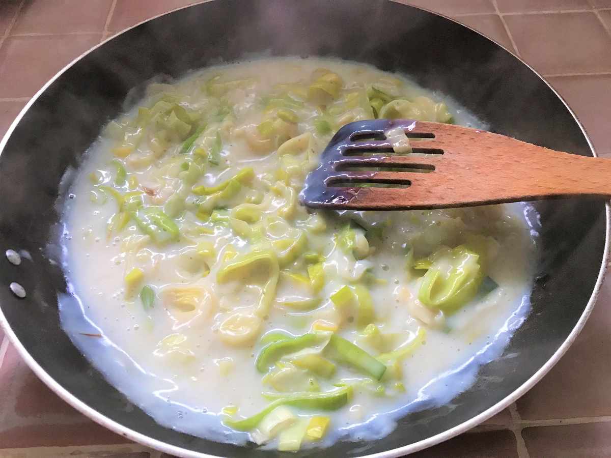 Leeks and low fat gluten free sauce in pan.