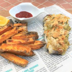 Healthy fish and chips on newspaper