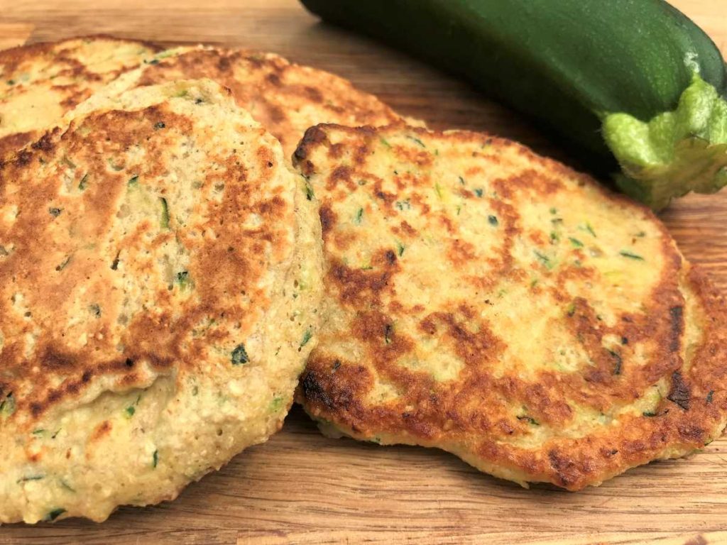 Courgette pancakes with courgette in background