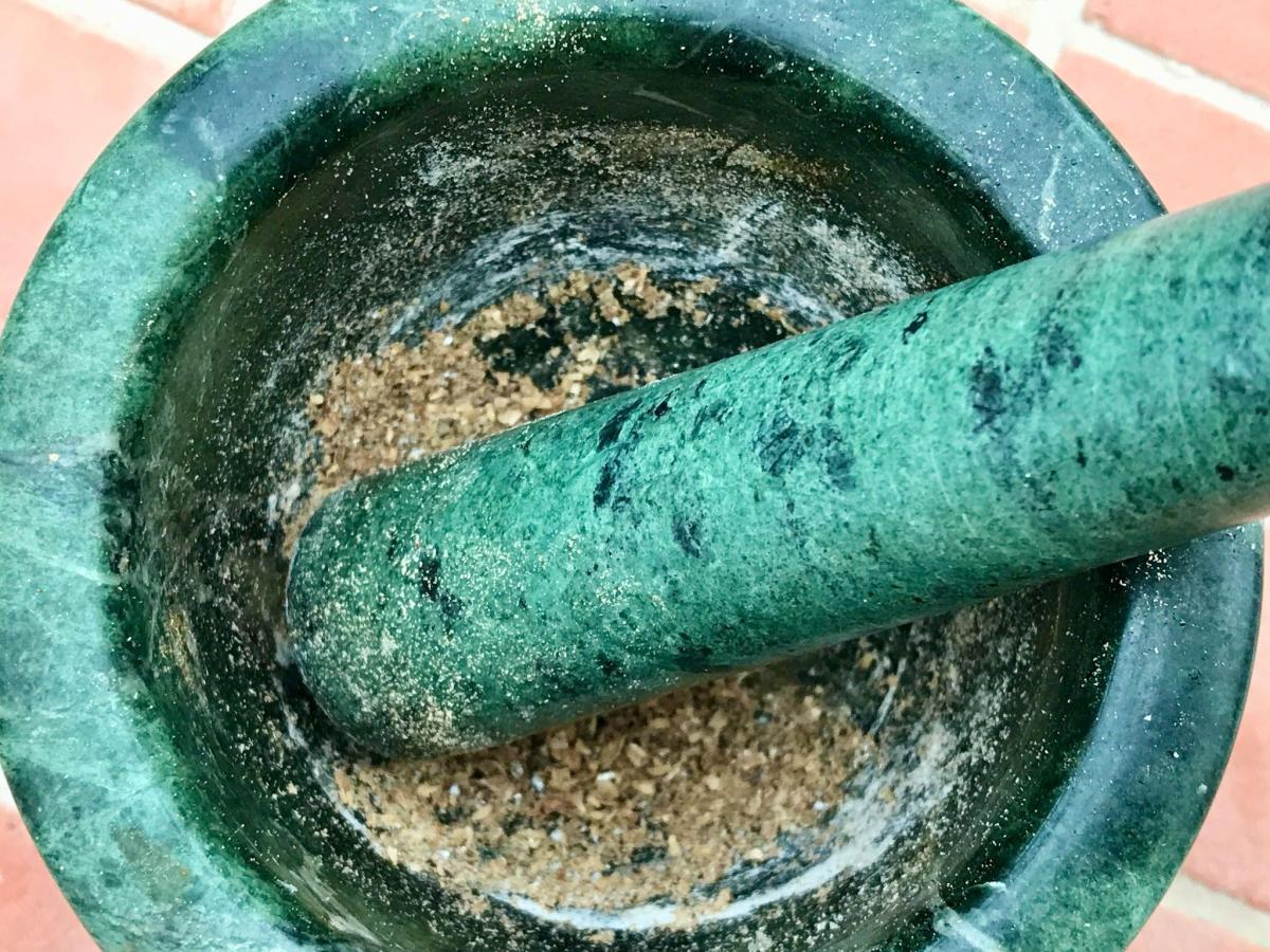 Crushing spices in mortar and pestle