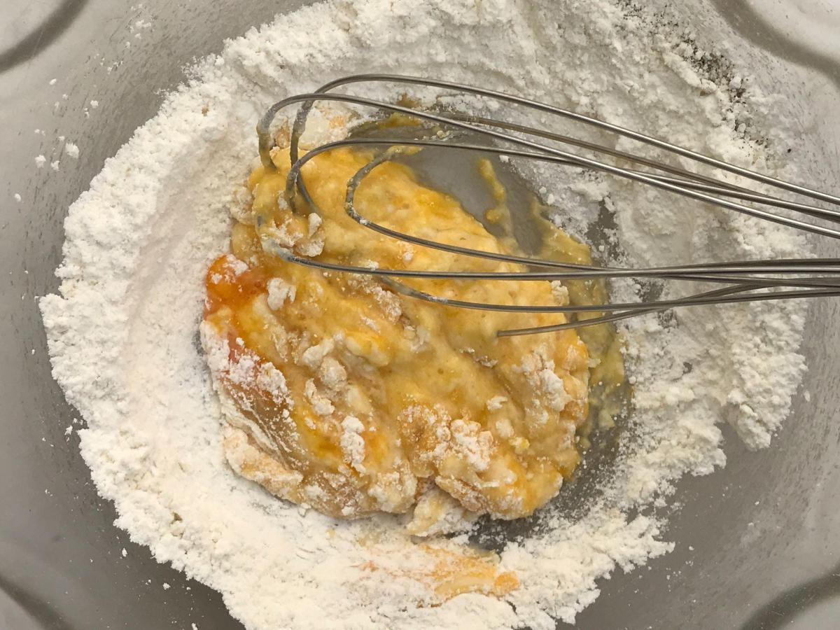 Mixing egg into flour