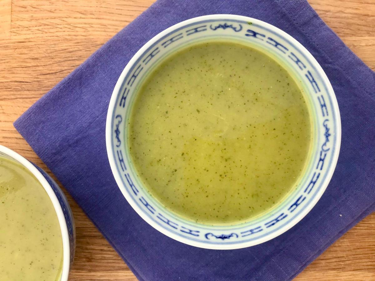 Healthy vegan zucchini soup on blue napkin