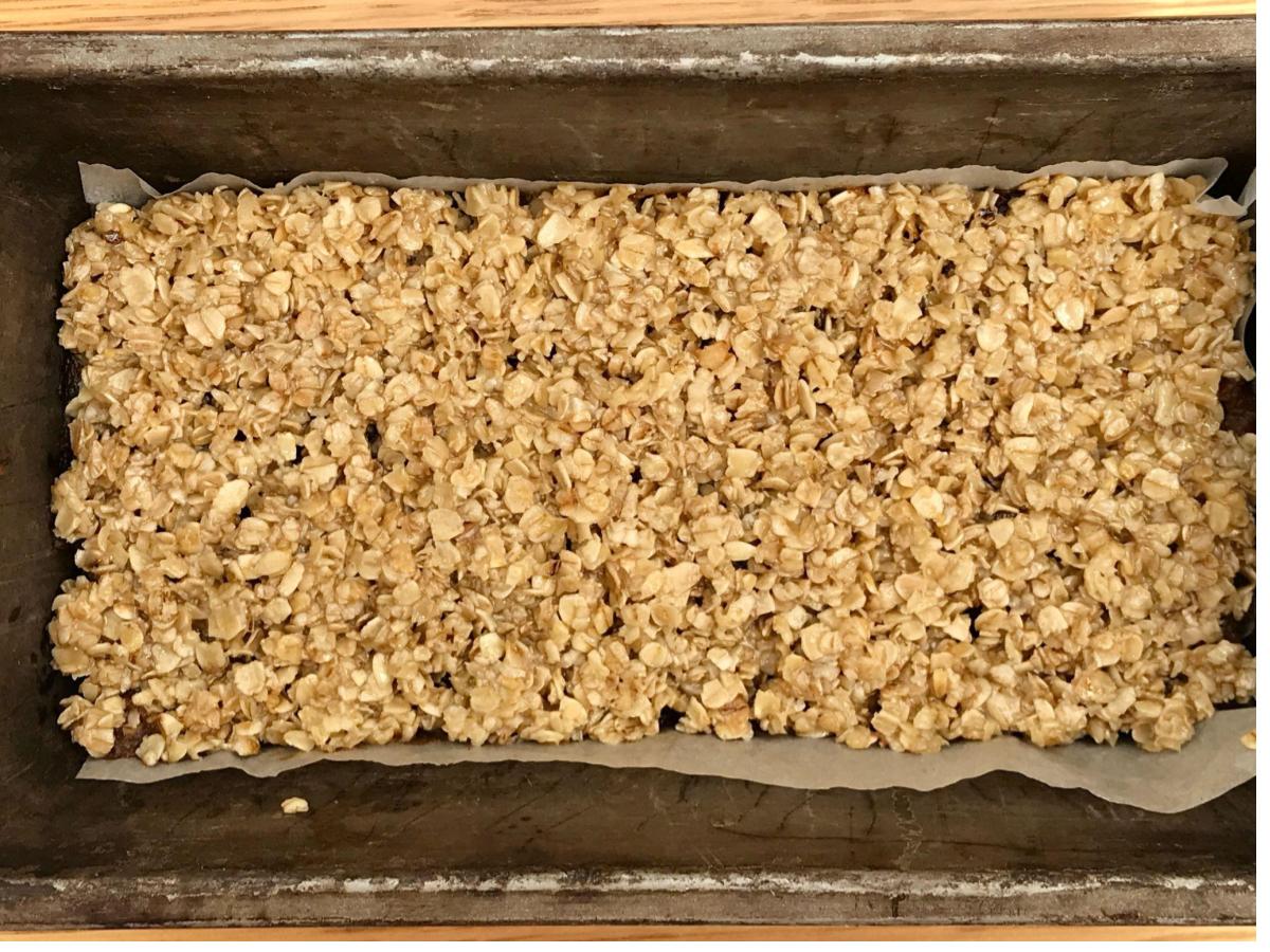 Raw date and oat slices in tin
