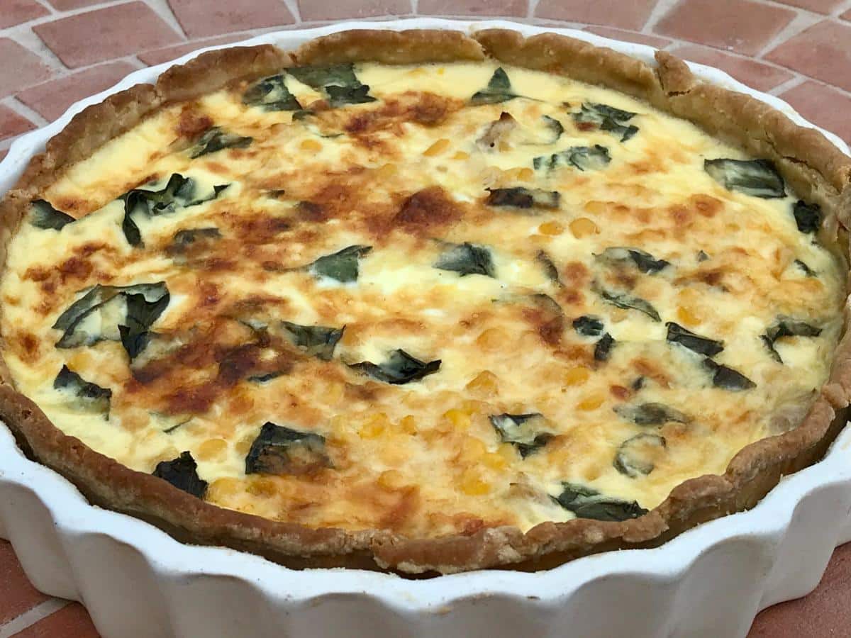 Cooked quiche in white flan dish