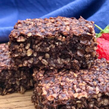 Healthy chocolate flapjacks with blue cloth and strawberries