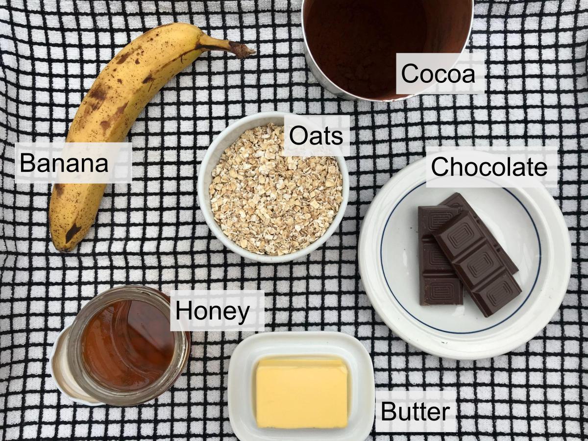 Ingredients for chocolate flapjacks banana oats cocoa honey butter chocolate