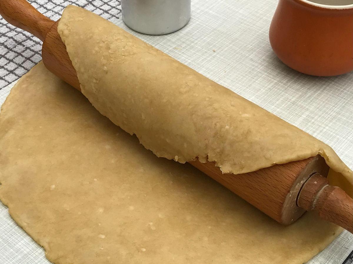 Pastry over rolling pin on board