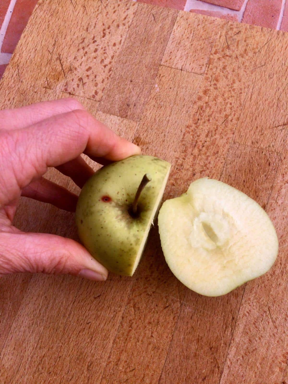 Preparing apples on wooden board.