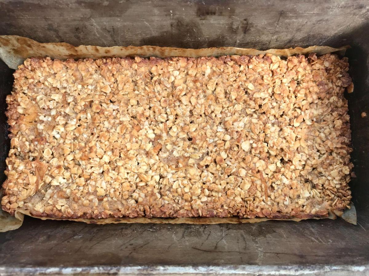 Cooked pear flapjack in tin.