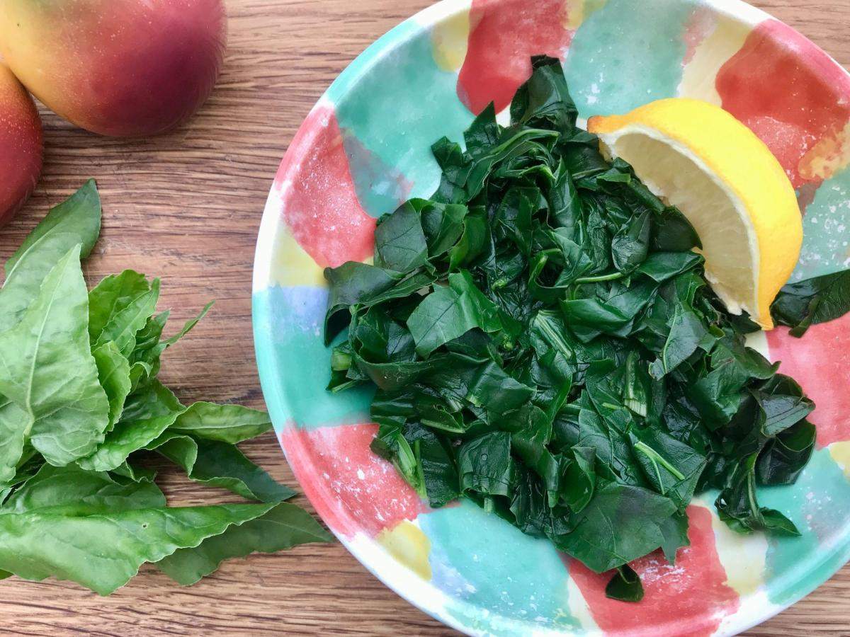 Cooked perpetual spinach in colourful bowl.