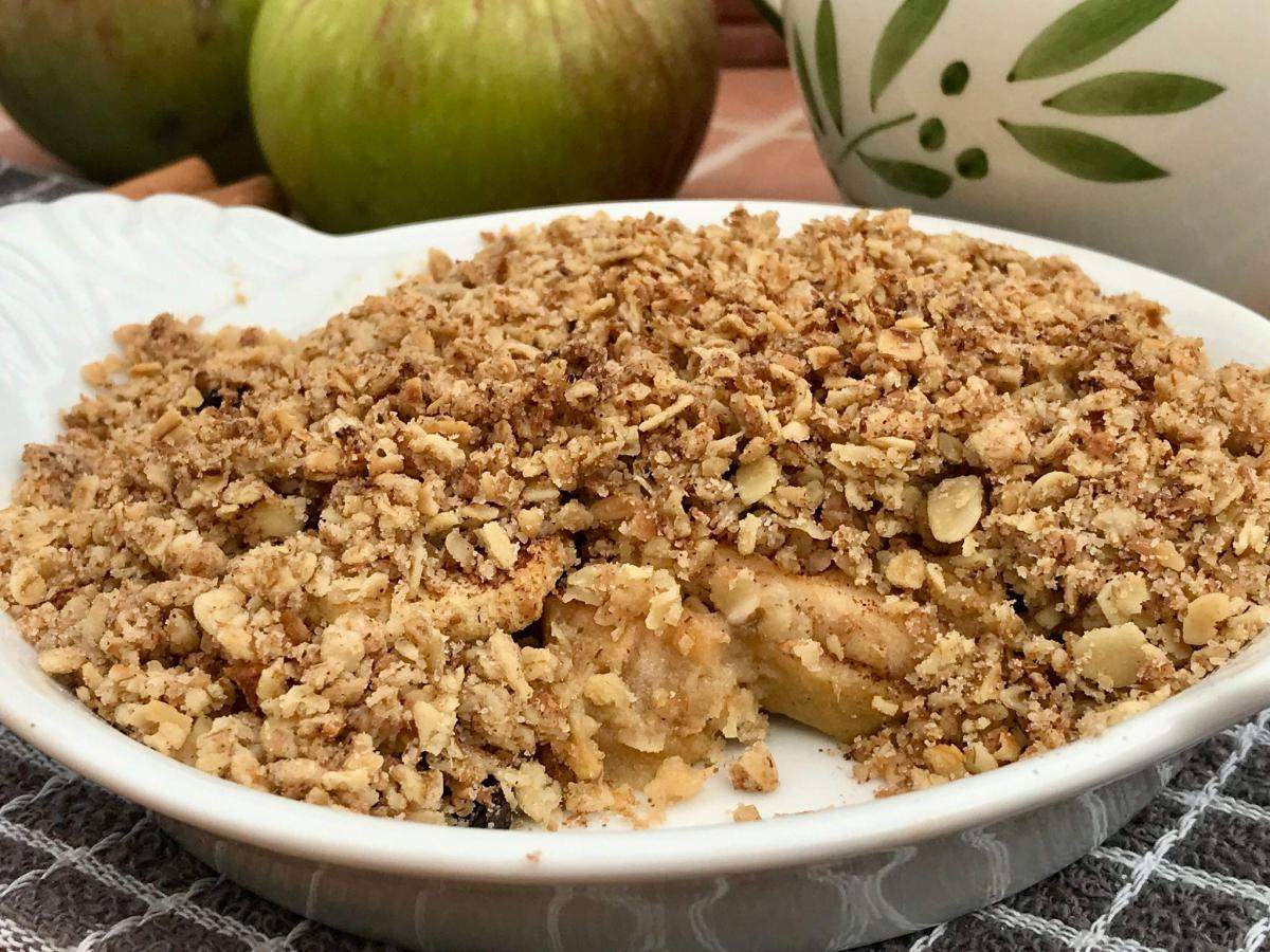 Crumble in dish showing cooked apple.