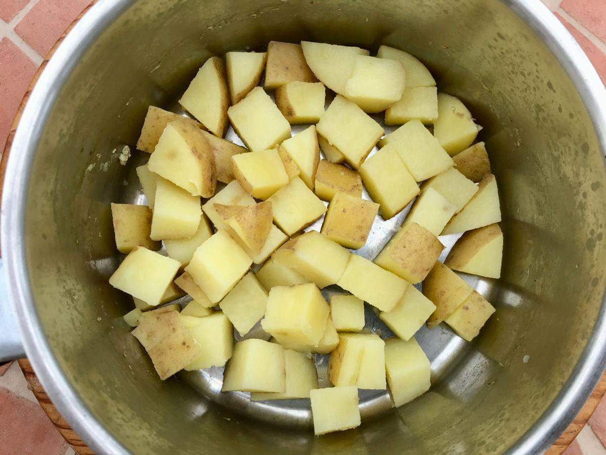 Cubed potatoes in pan.