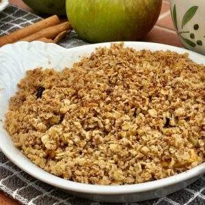 Dairy free apple crumble with apples and jug.