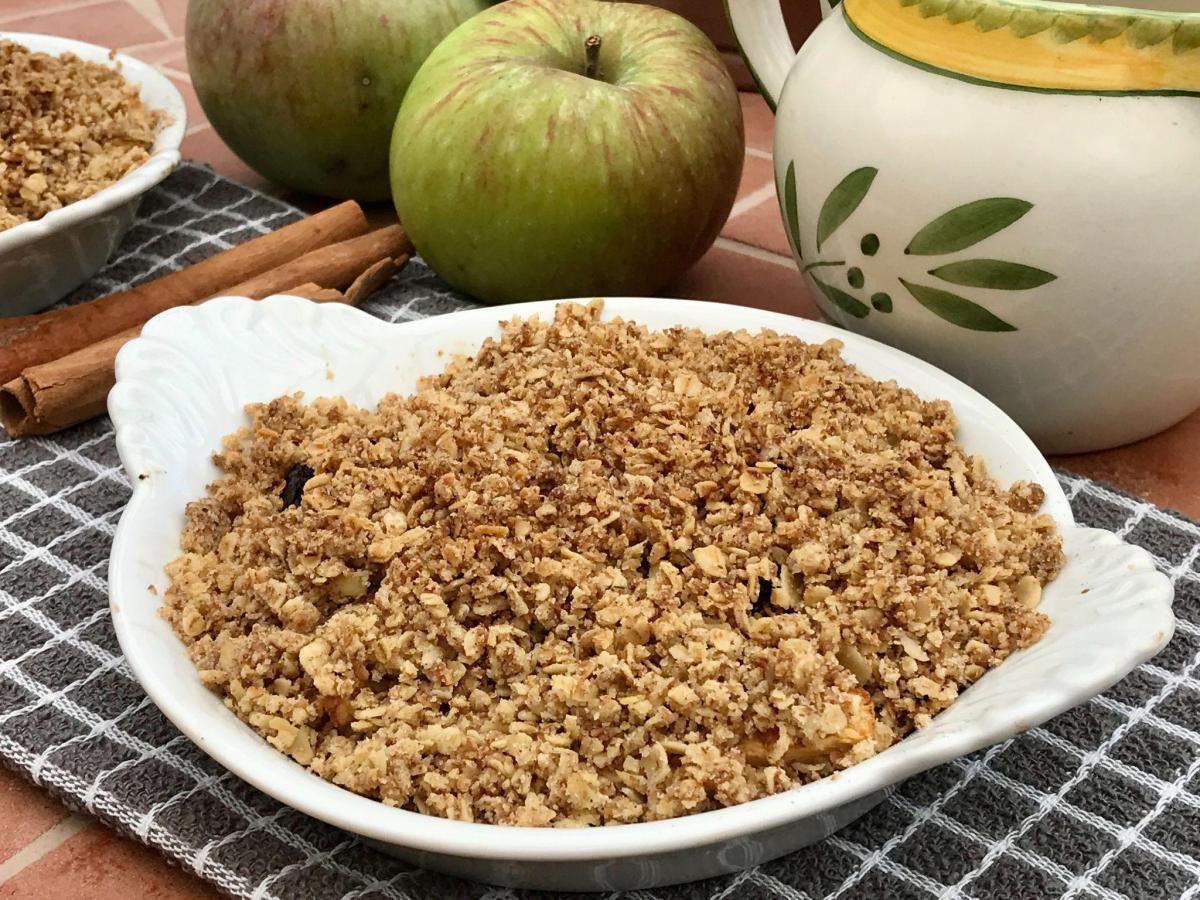 Dairy free apple crumble with apples and jug.