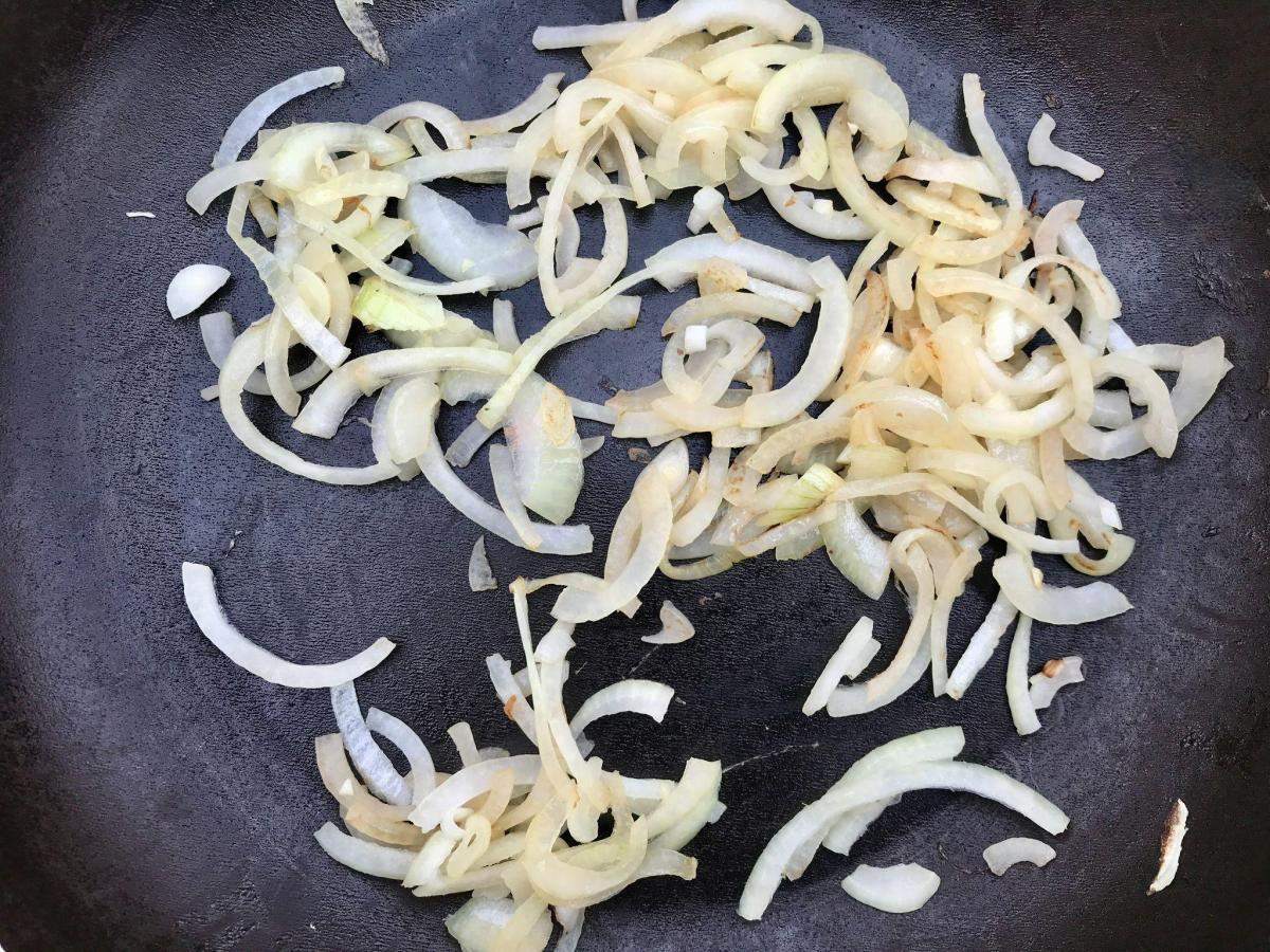 Fried onion in pan.
