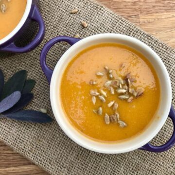 Healthy carrot and apple soup with sunflower seeds.
