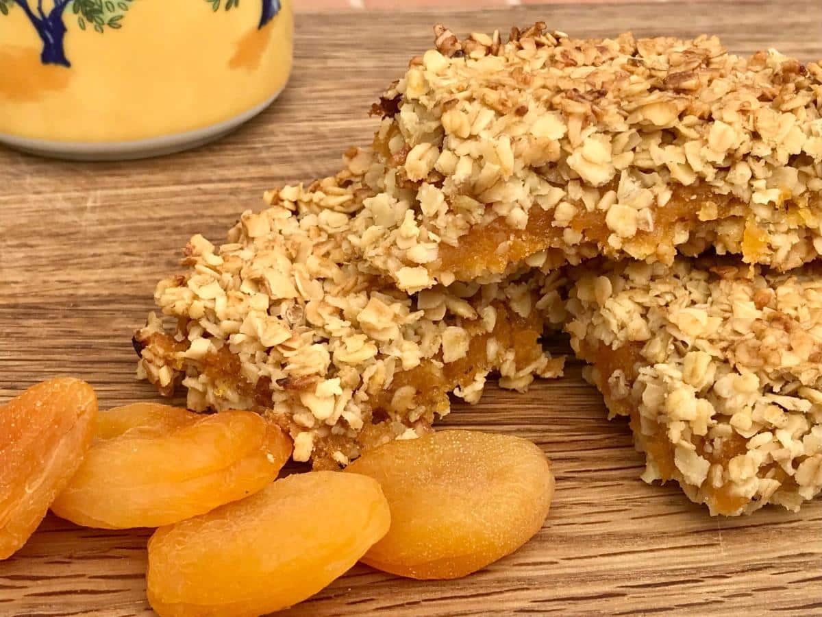Pile of apricot oat slices with dried apricots.