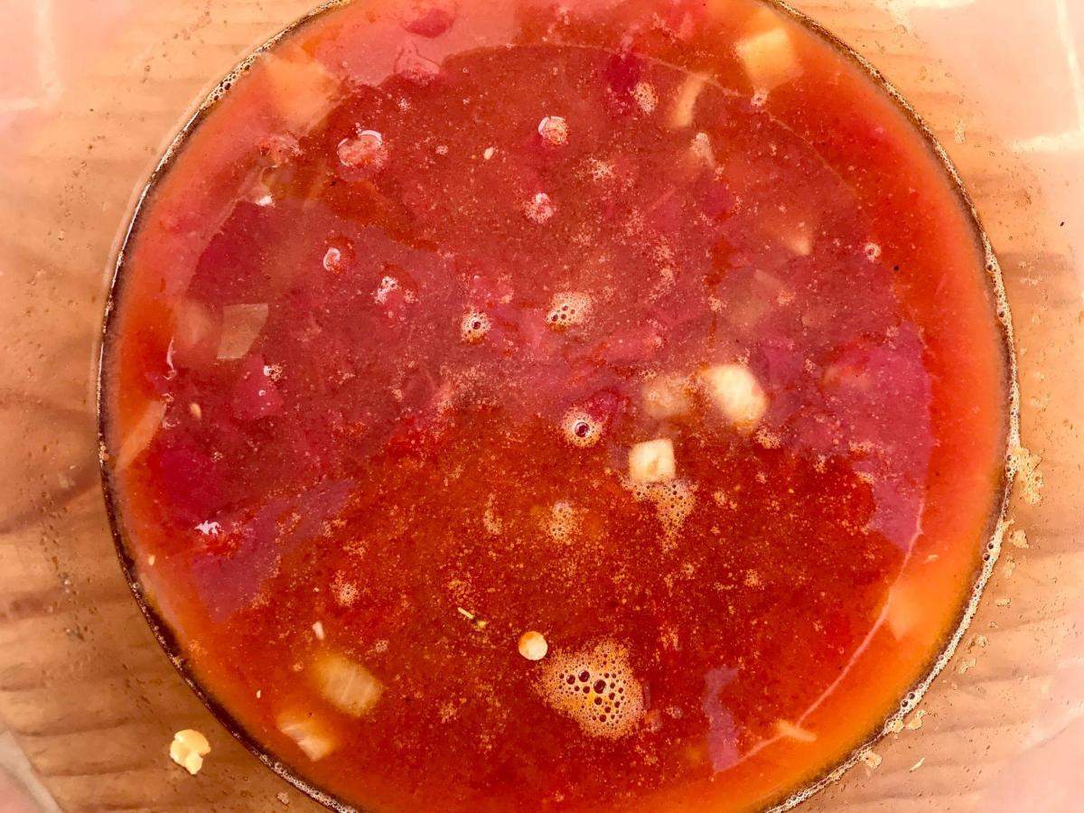 Tomatoes, onions, lentils and stock in pan.