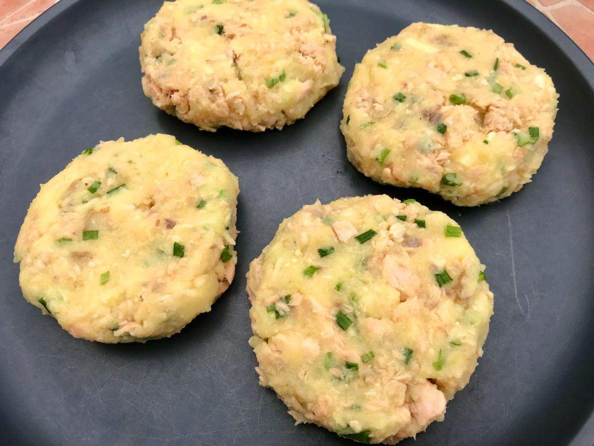 Uncooked fish patties on a plate.