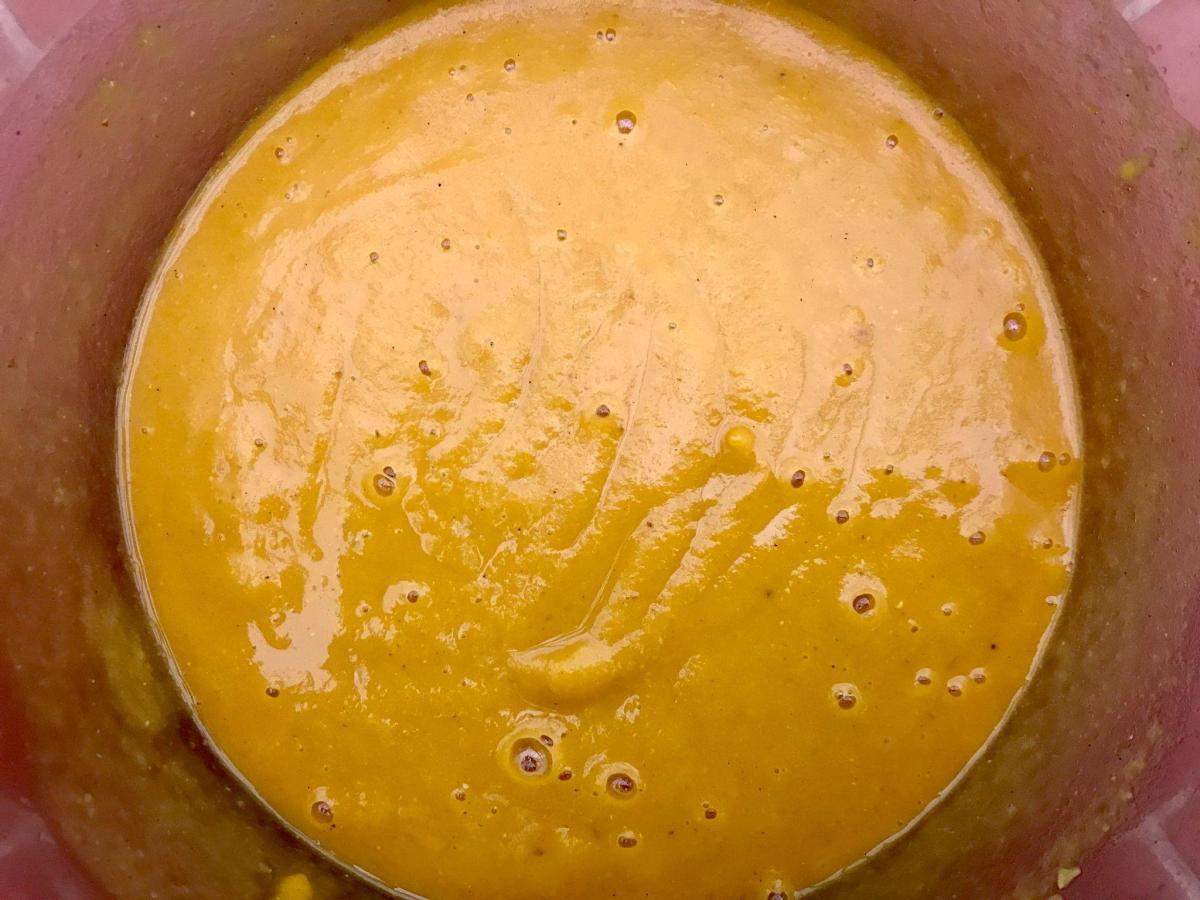 Blitzed red lentil and butternut soup in pan.