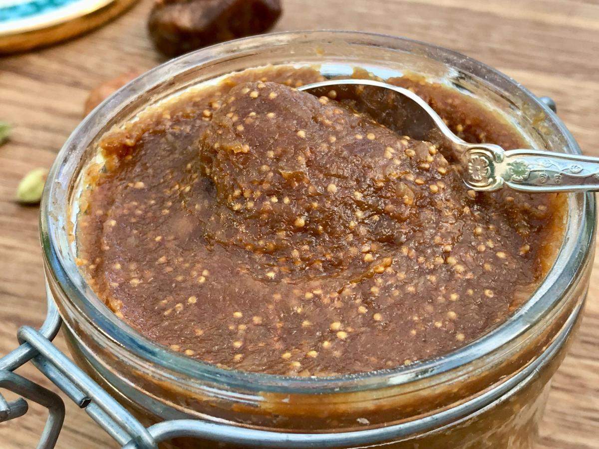 Fig paste in jar with spoon.