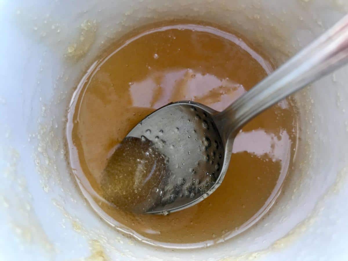 Melted gelatine in cup with spoon.