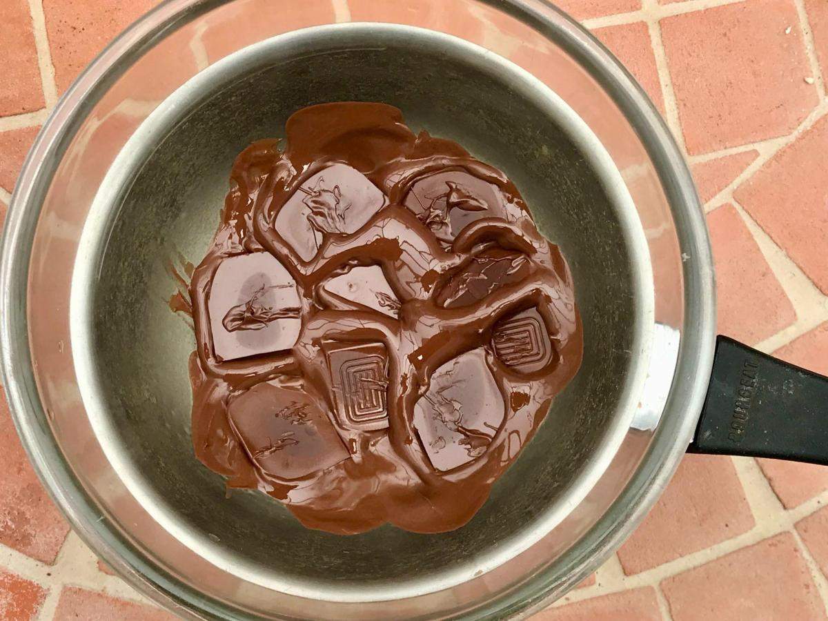 Melting chocolate in bowl over pan.