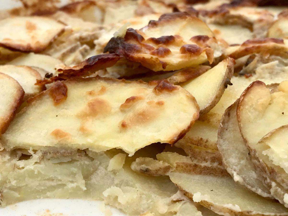 Dish of healthy low fat dauphinoise potatoes.