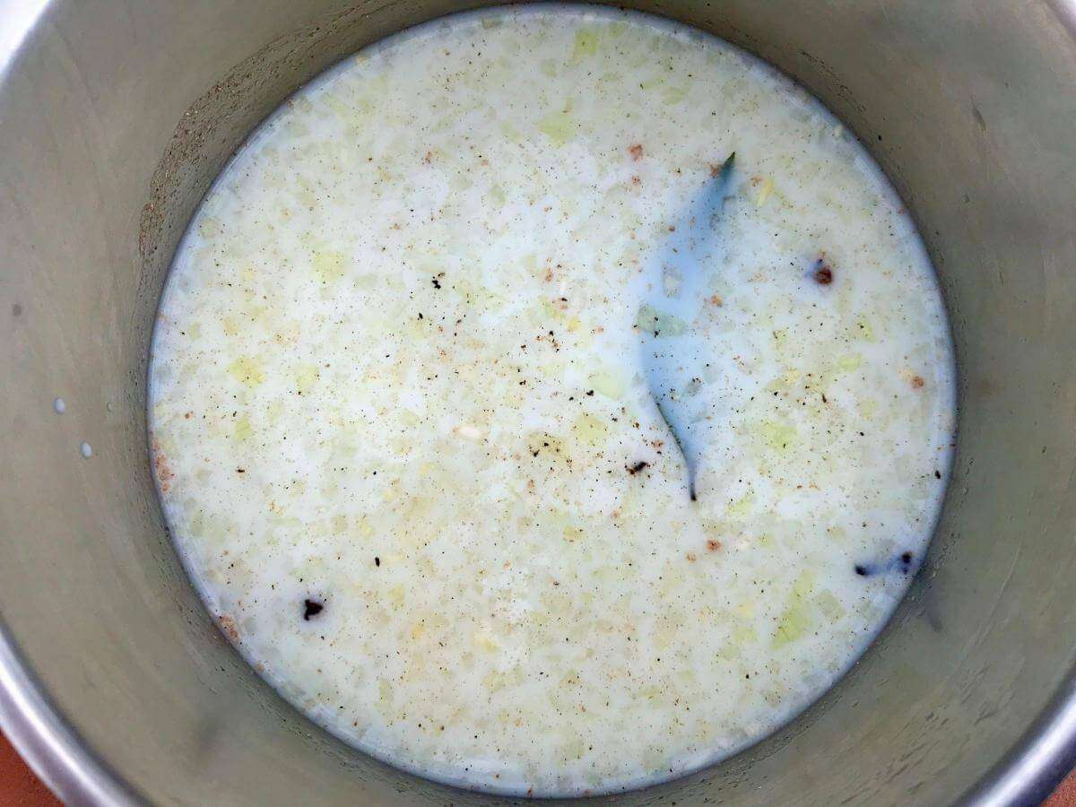 Milk with onion, bay leaf and spices.