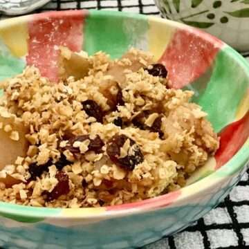 Serving of apple and mincemeat crumble in green bowl.