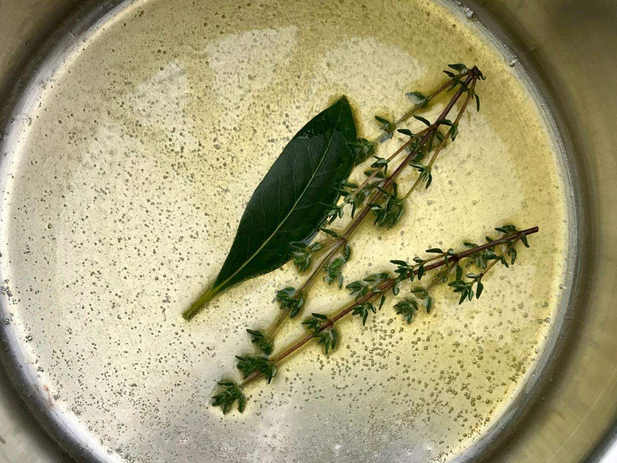Thyme and bay leaf in olive oil.