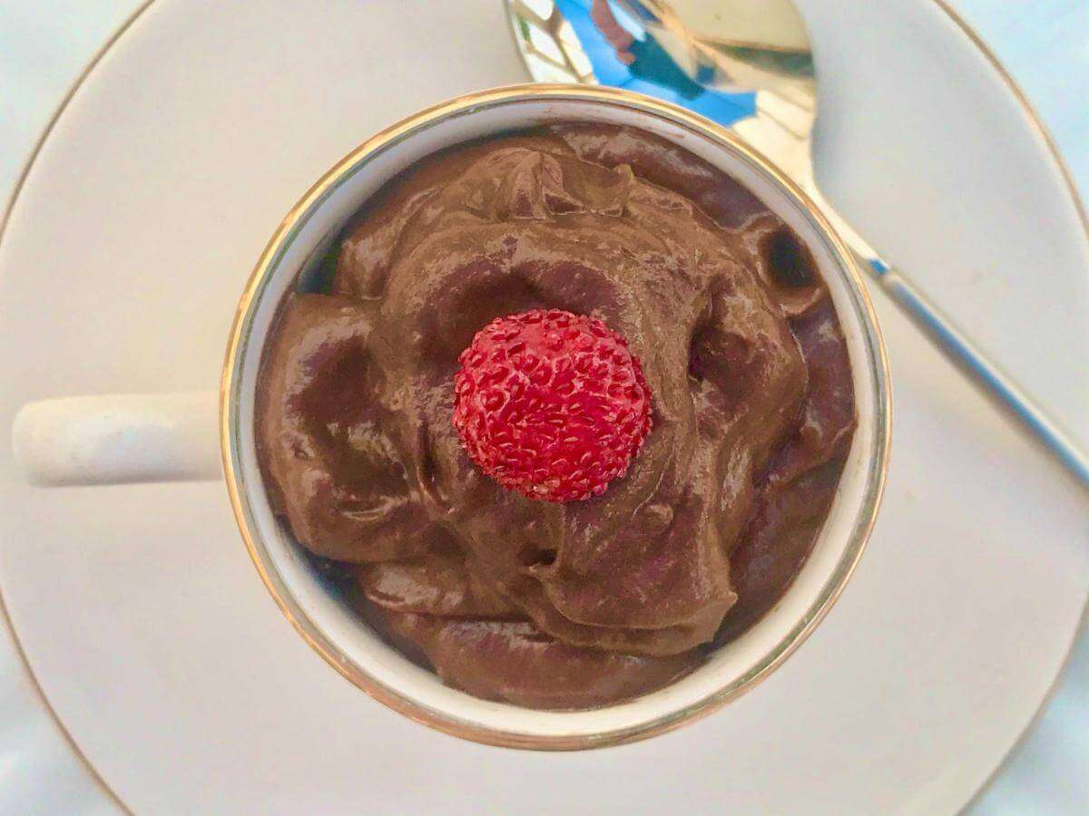 Avocado chocolate mousse in white cup.