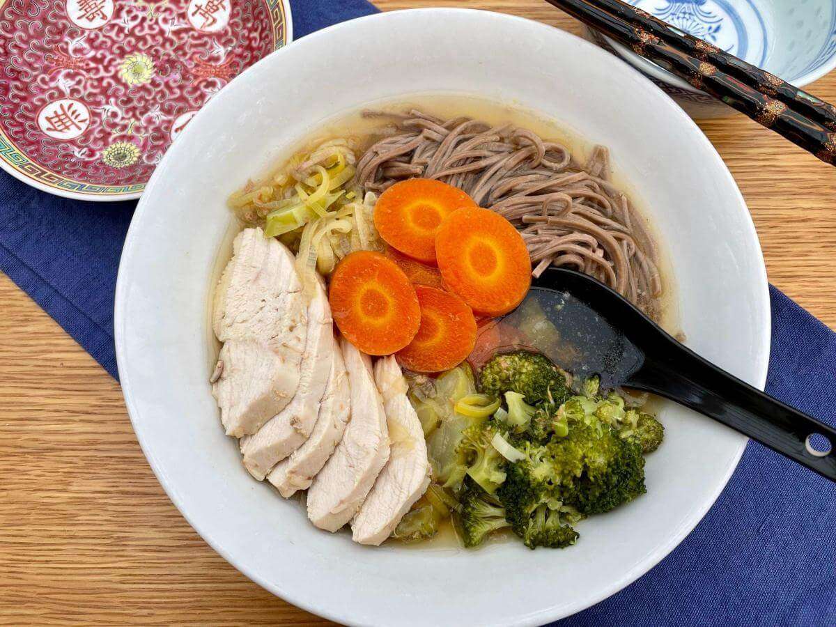 Chicken ramen noodles in white dish.