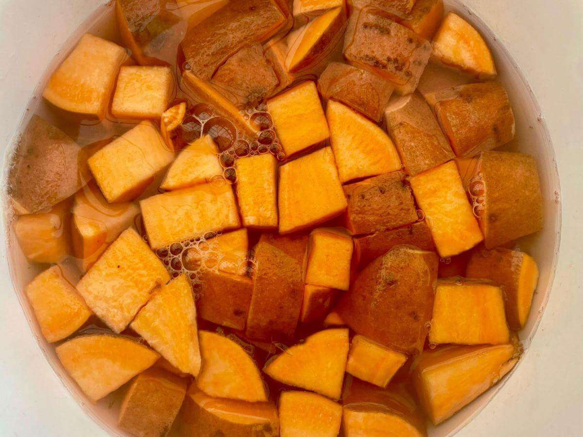 Diced sweet potato in pan.