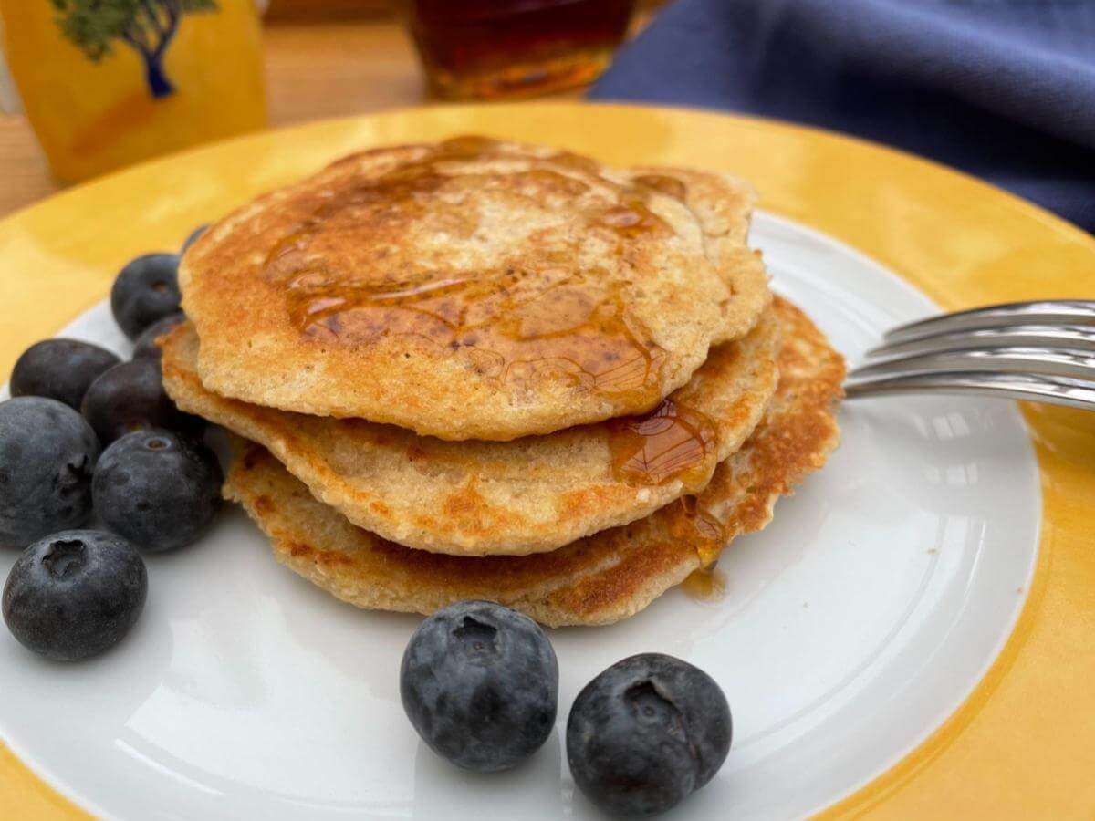 Stack of oat flour pancakes with blueberries.