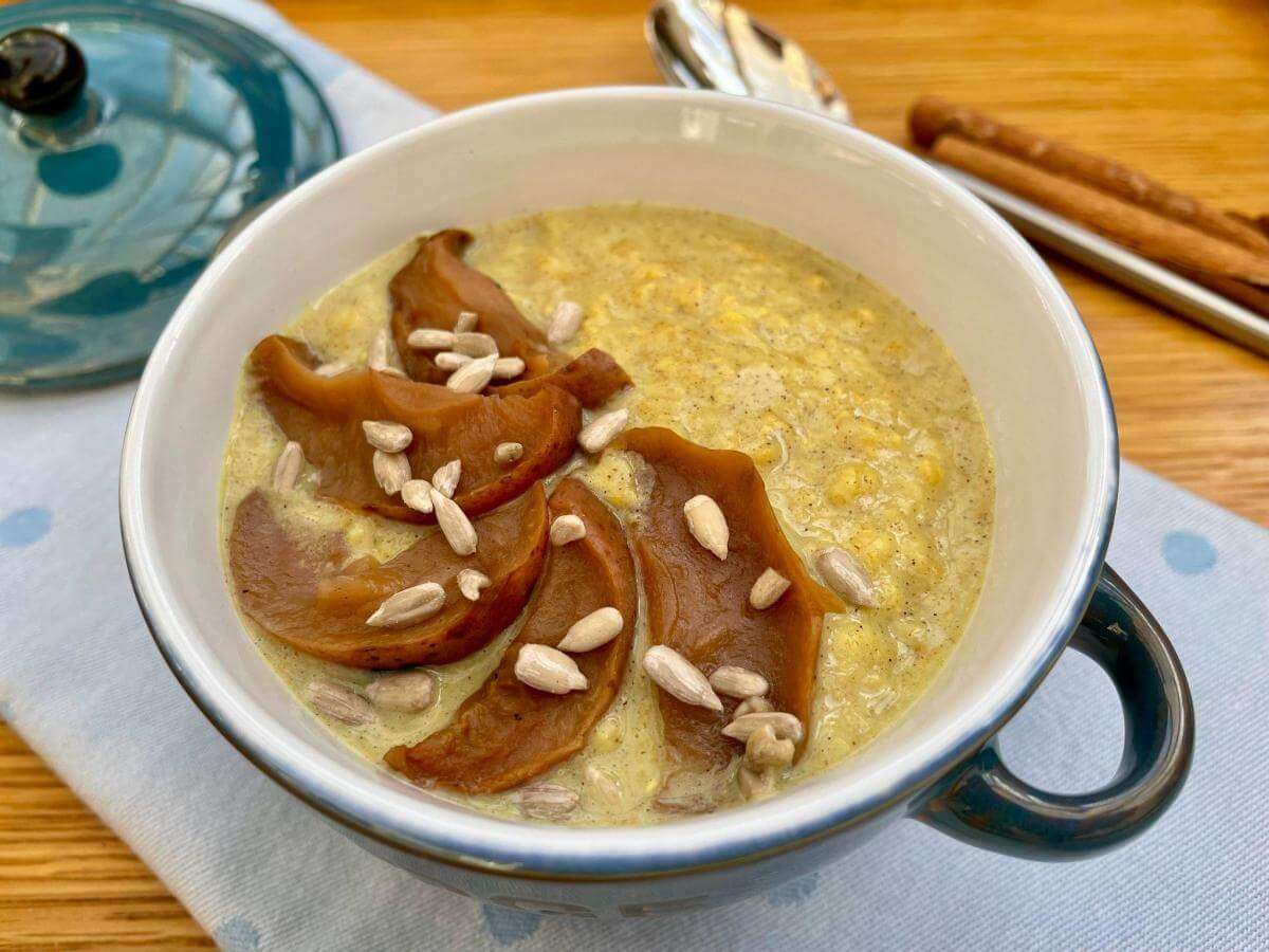 Spiced porridge in bowl with cooked apple.