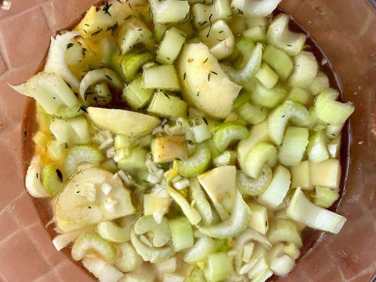 Apple celery and onion in pan.