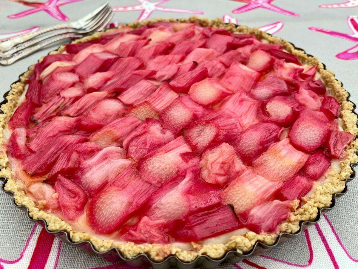 GF rhubarb and custard tart with pastry forks.