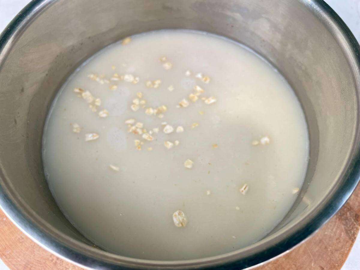 Oats and oat milk in pan.