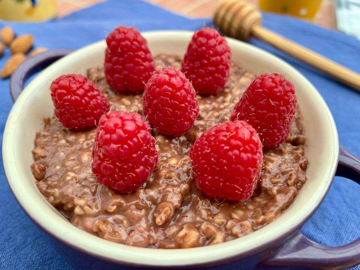 Healthy chocolate porridge with raspberries.