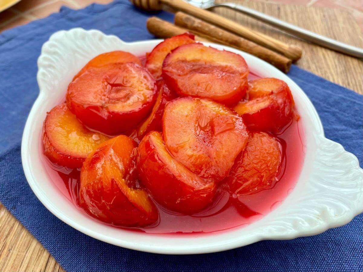 Poached plums with cinnamon sticks.