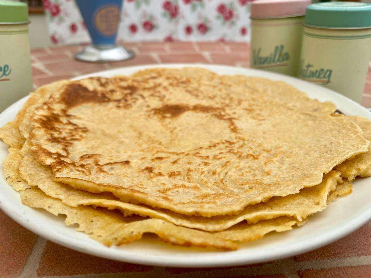 Stack of oat flour crepes on plate.