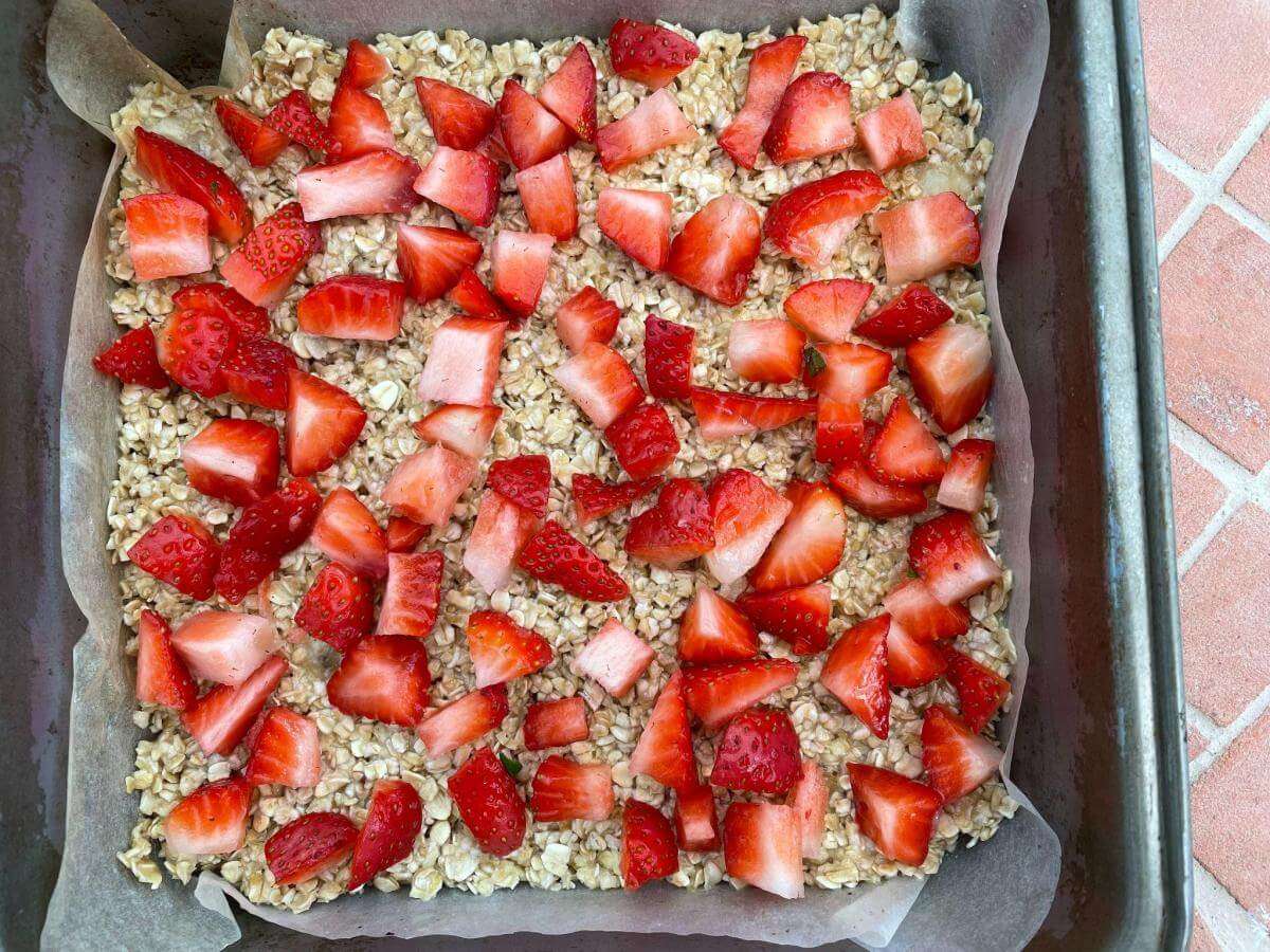 Flapjack mixture with layer of strawberries.