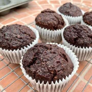Chocolate courgette muffins on wire rack.