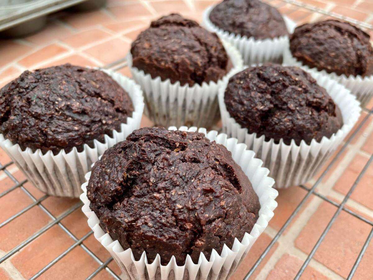 Chocolate courgette muffins on wire rack.