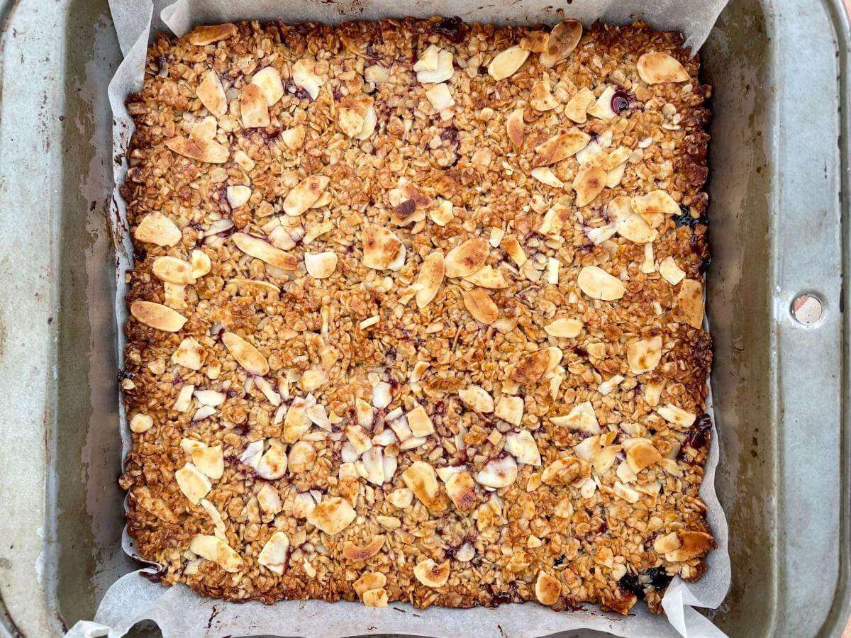 Tray of baked cherry bakewell flapjacks.