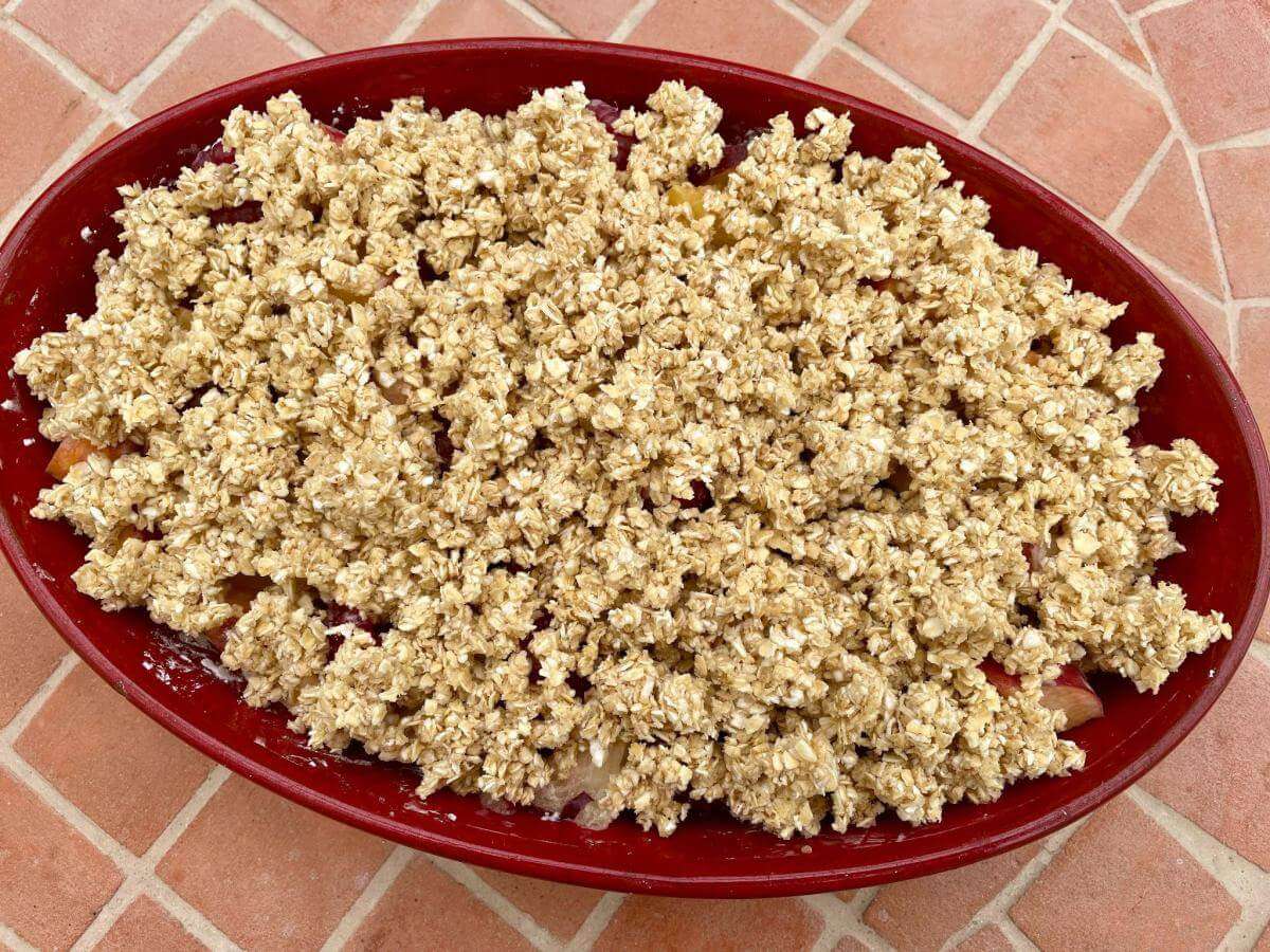 Uncooked peach crumble with oats.
