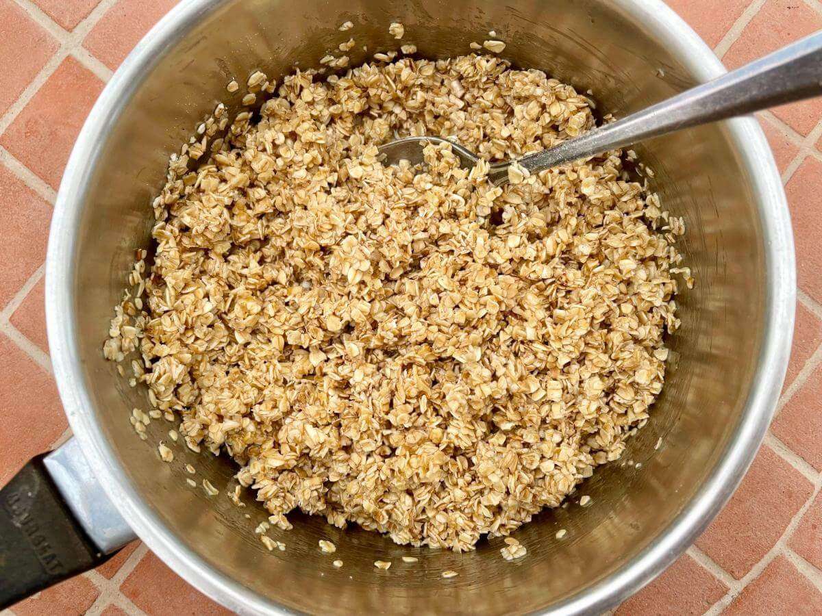 Butter oats and honey in pan.